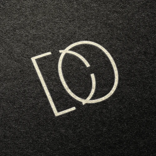 Minimalist personal logo design for Doga Ege Ozden, featuring stylized overlapping letters 'D' and 'E' inside a rectangular frame on a textured dark background.